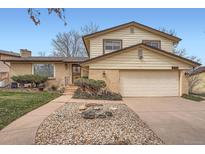 Charming two-story home featuring a well-maintained lawn, brick accents, and an attached two-car garage at 3245 S Nucla St, Aurora, CO 80013