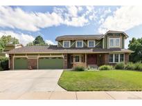 Charming two-story home with a three-car garage and well-manicured lawn at 1892 W Kettle Ave, Littleton, CO 80120
