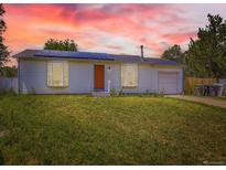 Charming single-story home featuring solar panels, a well-maintained lawn, and a welcoming front entrance at 10895 Fairfax Way, Thornton, CO 80233