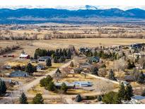 Expansive aerial view of a neighborhood with mountain views in the background at 833 Applewood Dr, Lafayette, CO 80026