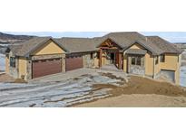 Two-story house with a three-car garage and a stone facade at 5320 Dual Rey Pt, Sedalia, CO 80135
