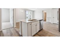 Modern kitchen features a kitchen island, stainless steel appliances, and contemporary finishes at 485 Interlocken Blvd # 209, Broomfield, CO 80021