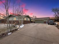 Charming exterior view of home with attached two-car garage and spacious driveway at 6535 Brentwood St, Arvada, CO 80004