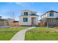 Charming two-story home featuring a well-manicured lawn and inviting walkway at 21134 E 63Rd Dr, Aurora, CO 80019