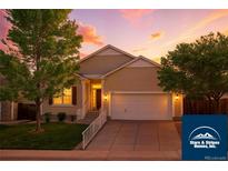 Charming two-story home with landscaped front yard and attached two-car garage at 5720 S Tempe Ct, Aurora, CO 80015
