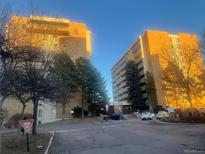 View of the brick residential buildings surrounded by mature trees and well-maintained landscaping at 8060 E Girard Ave # 504, Denver, CO 80231