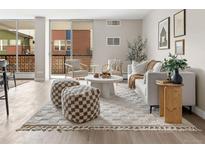 Bright living room with neutral décor, a sliding glass door, and modern furniture at 4570 E Yale Ave # 507, Denver, CO 80222