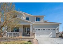 Charming two-story home with a well-maintained front yard and attached two-car garage at 9799 Falcon Ln, Littleton, CO 80125