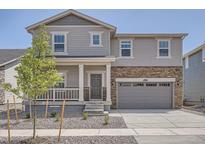 Charming two-story home featuring stone accents and a covered front porch at 15276 Fillmore St, Thornton, CO 80602