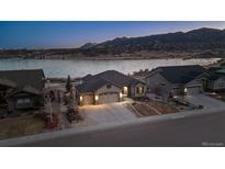 Charming single-Gathering home with a well-manicured front yard, three-car garage and lake views at 2891 Waterfront Dr, Monument, CO 80132