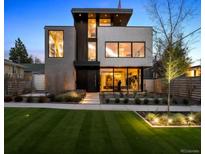 Stunning modern home featuring manicured lawn and beautiful landscaping for great curb appeal at 562 Steele St, Denver, CO 80206