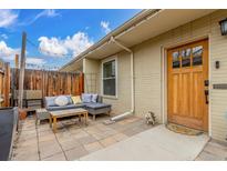 Cozy patio with a charming seating area, wooden fence, and a welcoming entrance to the home at 2841 N Columbine St, Denver, CO 80205