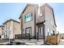 Attractive two-story home with a modern facade, a charming porch, and well-maintained landscaping at 10524 Eby Cir, Lone Tree, CO 80124