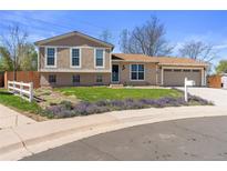 Charming two-story home with beautiful landscaping and an attached two-car garage at 1853 S Zeno Way, Aurora, CO 80017