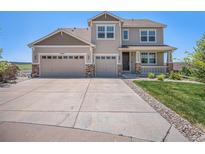 Charming two-story home with a three-car garage, front porch, and well-manicured landscaping at 5929 Echo Hollow St, Castle Rock, CO 80104