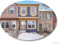 Tan and blue townhome exterior with snowy front yard at 2687 E Nichols Cir, Centennial, CO 80122