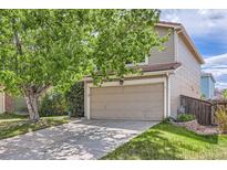 Charming home featuring a two-car garage, mature trees, and a well-maintained lawn at 4081 Odessa St, Denver, CO 80249