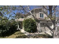 Charming two-story home features a well-kept lawn and an attached two-car garage at 4081 Odessa St, Denver, CO 80249