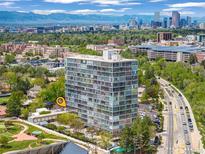 Stunning aerial view of high-rise condo building with panoramic city and mountain views at 3100 E Cherry Creek South Dr # 404, Denver, CO 80209