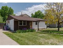 Charming single-story home with a well-maintained lawn and colorful landscaping at 1540 S Knox Ct, Denver, CO 80219
