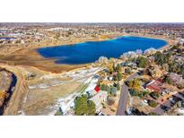 Stunning aerial view of a home near a picturesque lake, offering serene waterfront living with beautiful landscape at 14955 W 58Th Pl, Golden, CO 80403