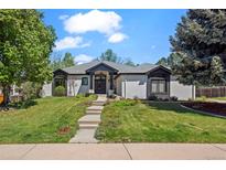 Charming single-story home with well-manicured lawn, lovely landscaping, and welcoming entry at 5302 Pinehurst Dr, Boulder, CO 80301