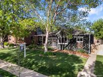 Charming home with mature trees, lush green lawn, and welcoming curb appeal at 2734 King St, Denver, CO 80211