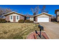 Charming brick home featuring a well-maintained lawn and a two-car garage at 6036 S Colorado Blvd, Centennial, CO 80121