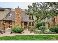 Charming home featuring a brick chimney, well-manicured landscaping, and a welcoming front entrance at 8170 E Phillips Cir, Centennial, CO 80112