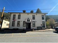 Charming multi-story exterior with classic architectural details and a welcoming entrance with benches at 614 Rose St, Georgetown, CO 80444