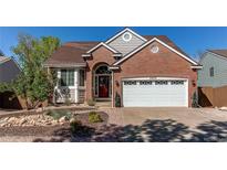Charming brick home featuring a well-manicured front yard and attached two-car garage at 3644 Rosewalk Cir, Highlands Ranch, CO 80129