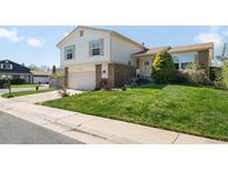 Charming two-story home with a well-manicured front yard and attached garage at 11011 Kendall Way, Westminster, CO 80020