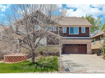Charming two-story home featuring a two car garage, mature landscaping, and beautiful architecture at 12451 Turquoise Terrace Pl, Castle Pines, CO 80108