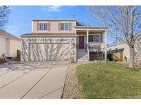 Charming two-story home with a two-car garage, inviting porch, and well-maintained landscaping at 20466 Willowbend Ln, Parker, CO 80138