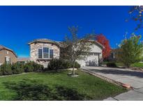 Ranch style home with stone accents and landscaped yard at 4831 Sunshine Pl, Broomfield, CO 80023