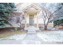 Inviting home entrance with classic columns, stone accents, and a well-maintained walkway at 8423 S Miller Ct, Littleton, CO 80127
