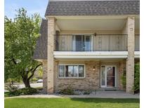 Charming two-story condo with brick facade and a covered balcony, perfect for outdoor relaxation at 6711 S Race St, Centennial, CO 80122
