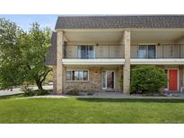 Inviting exterior view of townhome featuring a brick facade, balcony, and well-maintained lawn at 6711 S Race St, Centennial, CO 80122