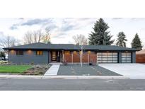 Modern gray brick ranch home with a landscaped front yard and attached two-car garage at 6795 W 35Th Ave, Wheat Ridge, CO 80033