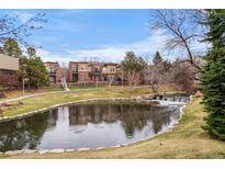 Exterior view of townhomes with water feature and a beautifully landscaped lawn at 9071 E Phillips Dr, Centennial, CO 80112