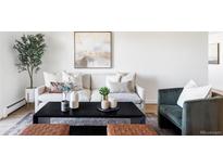Stylish living room features a comfortable sofa, modern art, and decorative accents at 745 S Alton Way # 11B, Denver, CO 80247