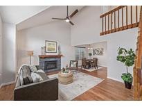Inviting living room boasts a fireplace, high ceilings, and lots of natural light at 116 S Lindsey St, Castle Rock, CO 80104