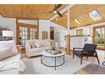 Inviting living room featuring wood ceilings, skylights, plush seating, and a ceiling fan at 270 31St St, Boulder, CO 80305