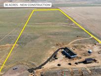 Expansive aerial view showcasing a new construction home on a large 36-acre lot at 61800 E 32Nd Ct, Strasburg, CO 80136