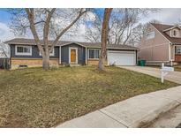 Charming single-Gathering home with an attached garage, a manicured front lawn and mature trees at 9068 Dudley St, Broomfield, CO 80021