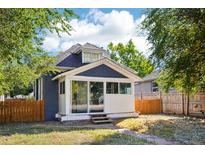 Charming bungalow with a spacious sun porch and fenced backyard at 3930 Sheridan Blvd, Denver, CO 80212