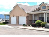 Charming home featuring a two-car garage, inviting front porch, and well-maintained landscaping at 1343 Villa Grv, Monument, CO 80132