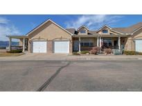 Attractive exterior view of townhomes with well-kept lawns and appealing front facades at 1343 Villa Grv, Monument, CO 80132