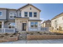 Charming townhome featuring a stone facade and inviting front porch, perfect for enjoying the neighborhood views at 1961 S Haleyville Way, Aurora, CO 80018