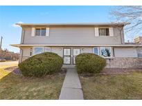 Two-story home featuring stone accents, tidy landscaping, and a well-maintained walkway at 6905 Mariposa St # C, Denver, CO 80221